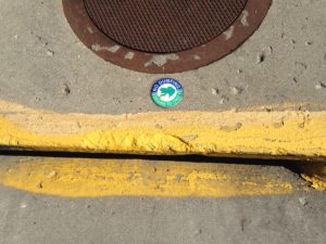 Storm drain label: "No dumping - drains to creek"
