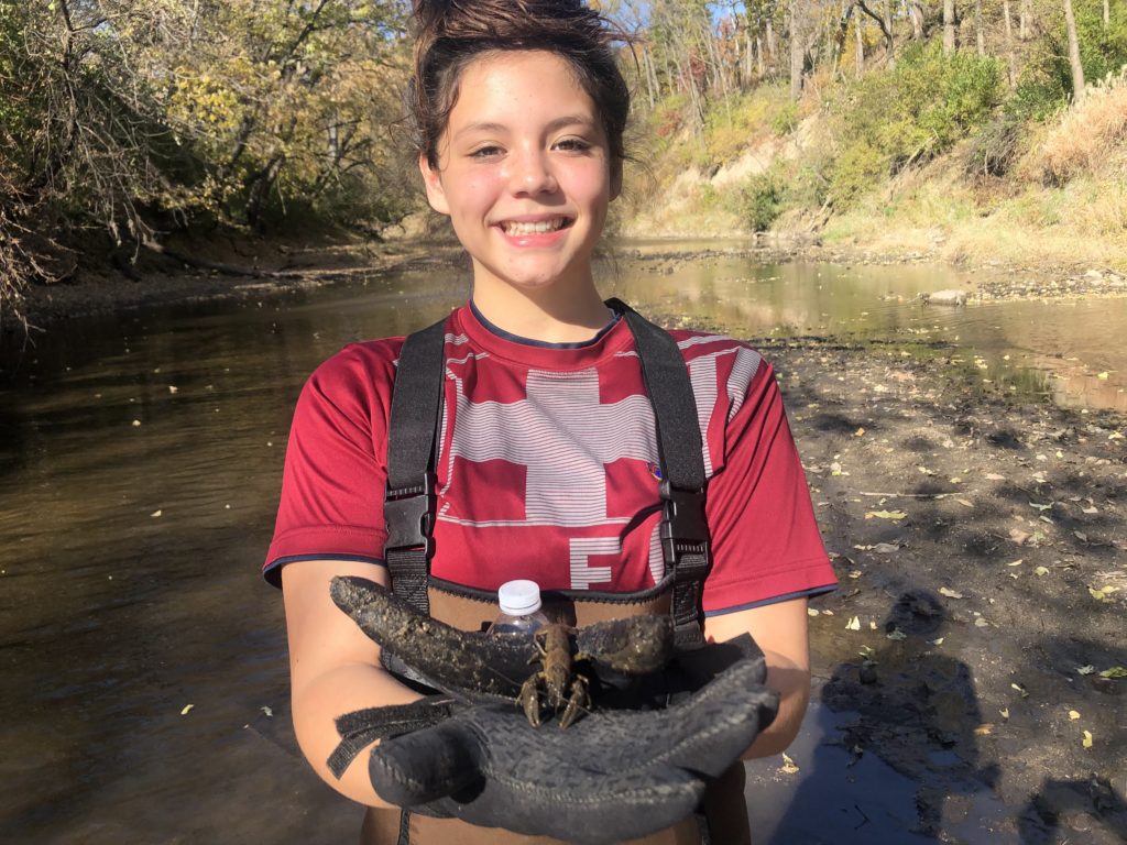 Ames High School student with crayfish