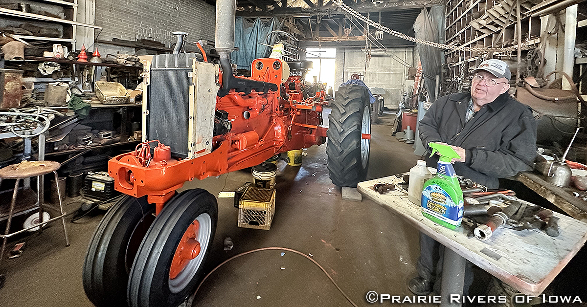 Bill Sankot in his garage with a Case tractor restoration project.