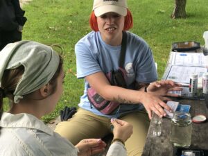 Amelia Whitener leads a water monitoring demonstration at a trash cleanup event.