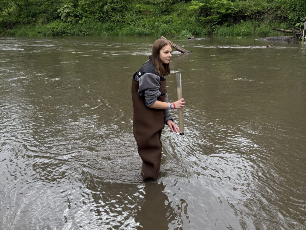 An Ames High student tests water clarity in Ioway Creek