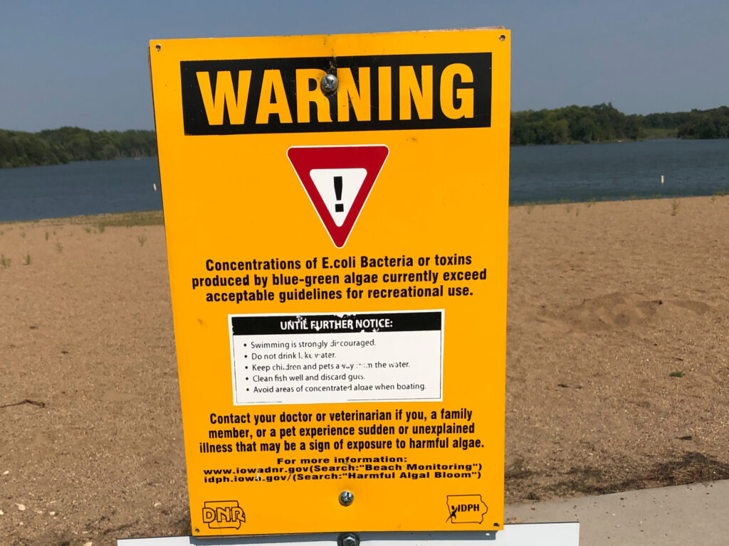 Warning sign posted at beach for water quality advisory